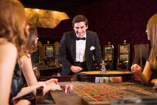 A stylish woman beside vibrant slot machines displaying glowing sevens, showcasing the variety of top slots at OKTKK.